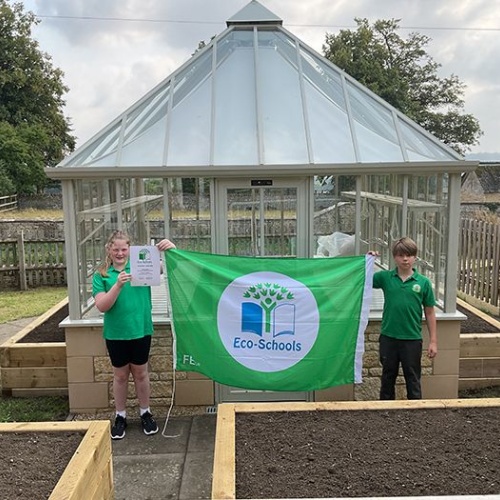 Eco school certificate outside the new greenhouse